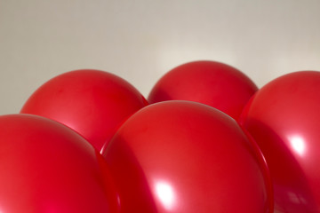 red helium balloons on beige background