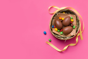 Easter chocolate eggs and candies on a pink background. have copy space. Easter concept for kids