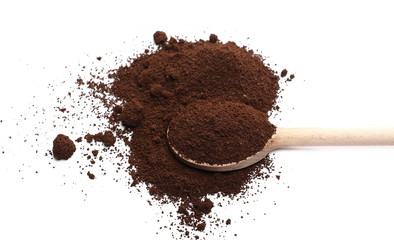 Milled coffee powder for espresso with wooden spoon isolated on white background