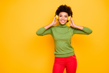 Fototapeta premium Portrait of her she nice attractive lovely pretty cheerful cheery brown wavy-haired girl listening cool music soul funk isolated over bright vivid shine vibrant yellow color background