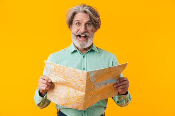 Happy grey-haired man holding map.