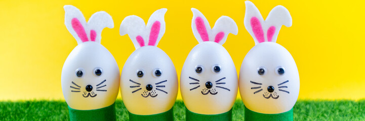 Happy Easter background. Creative Easter egg decoration ideas with easter bunny on yellow. Funny...