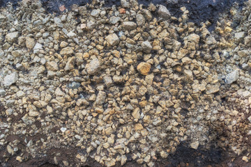 Detailed texture of gray and yellow crushed stone. Abstract background
