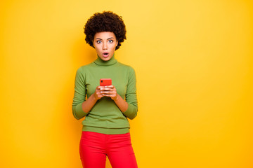 Photo of scared shocked woman afraid of fake news spreading holding telephone receiving negative...