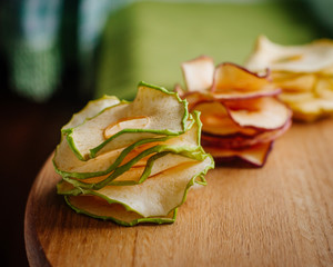 Dried apple slices in craft paper package on wooden background