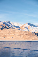 White and yellow sandy mountain with snow covered located in Xinjiang China Tashkurgan(Taxkorgan).