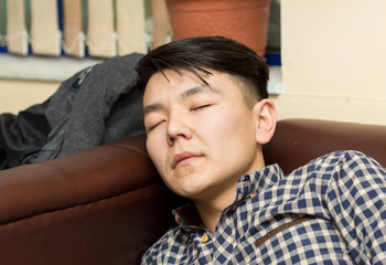 young man sitting on the couch and watching TV