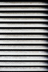 Obraz premium Industrial vent white dirty grill texture with parallel horizontal aluminium inclined shutters planks with net in the far side