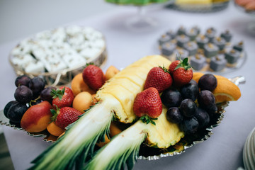 Plate with fruits and berries at a wedding banquet, serving