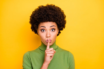 Close up photo of pretty cute sweet girlfriend showing you shh sign to stop your talking with...