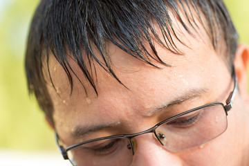 Portrait of a young man with glasses in the street