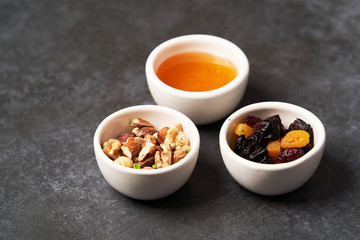 Healthy breakfast snacks for Oatmeal porridge. Dry raisins, honey and nuts