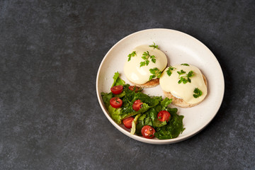 Eggs benedict with bacon meat and fish, close-up