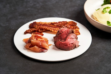 Eggs benedict with bacon meat and fish, close-up