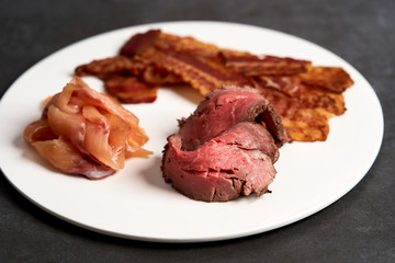 Eggs benedict with bacon meat and fish, close-up