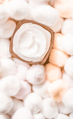 Luxury face cream for sensitive skin and orange cotton balls on background, spa cosmetics and...