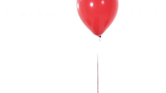 Close-up demonstration video of a red balloon flying up and disappearing from camera view. Inflatable balloon. Isolated, on white background