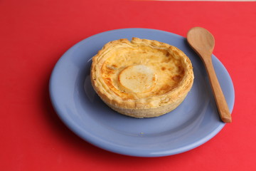 Delicious three cheese quiche in colored background