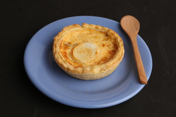 Delicious three cheese quiche in colored background