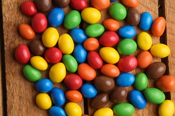 Fototapeta na wymiar delicious colorful chocolate balls stuffed with peanut