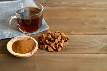 chaga tea mushroom from birch tree using for healing tea or coffee in folk medicine. ground powder