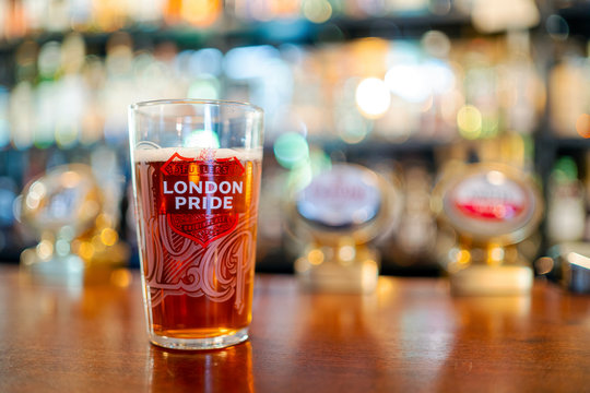 Glass of cold London Pride beer served in English pub, UK