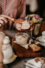 The girl has a big plan to smear the toast with pate