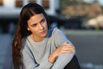 Sad teenage girl looks away in the street