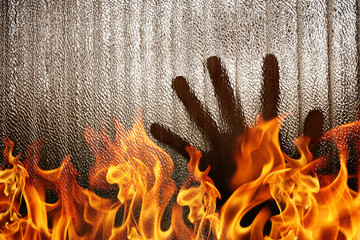 Silhouette of a hand the expression to need help with blaze fire flame