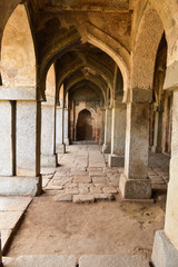 A mesmerizing view of inside the monument of hauz khas lake and garden from the hauz khas fort at hauz khas village at winter foggy morning.