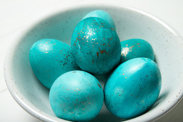 Easter eggs in a plate on a white background. Easter. Easter eggs. Close-up