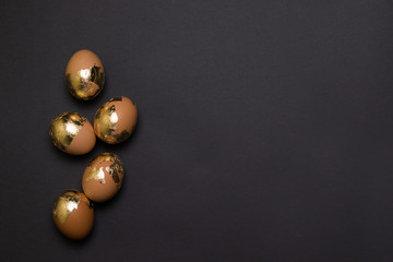 Gold decor chicken egg on black background