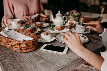 Two girls drink tea in a restaurant with custard buns / big plan