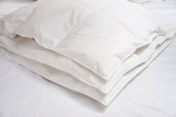 Fototapeta na wymiar White blanket (quilt) on the bed