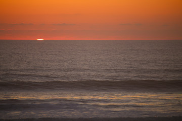 Naklejka na ściany i meble Sunset on the ocean with beautiful clouds