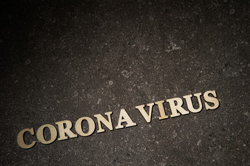 Word coronavirus on stone texture background 