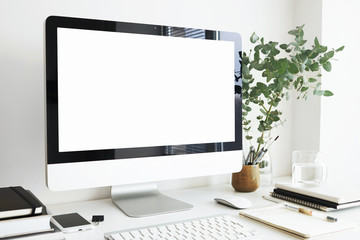 Side view of stylish modern workspace in light room. Generic desktop computer with blank white display with copy space for your design, text, information and advertising content. Nobody around - obrazy, fototapety, plakaty