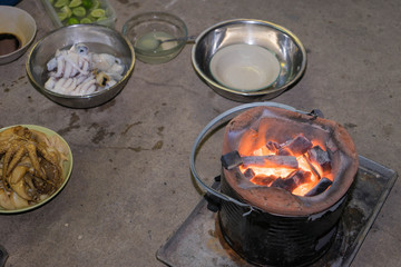 Thai traditional brazier prepared for roasting squid.