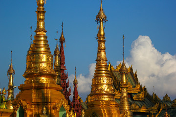 Gold-plated Elements of an ancient pagoda in Myanmar at sunset