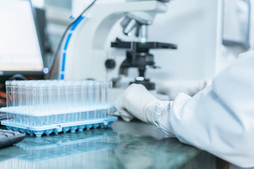 Microscope and test tubes on the desk