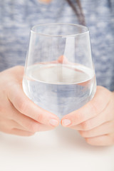 close up glass of water in hands 