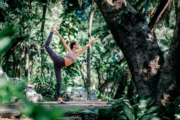 Transforming energy. Full-length shot of caucasian woman standing in Dancer's pose, Natarajasana...