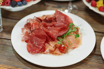 Jamon. Thin meat cutting. Delicious meat on the holiday table.