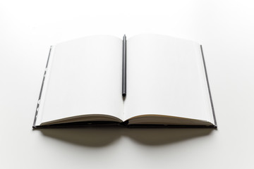 Empty blank white page in a paper note book with pencil for writing ideas and notes