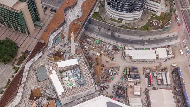 Construction progress of new shopping mall in Dubai city aerial timelapse, United Arab Emirates. Cranes and building equipment in financial district near downtown