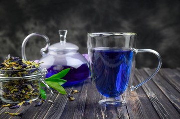 Cup and teapot butterfly pea flower blue tea. Healthy detox herbal drink.