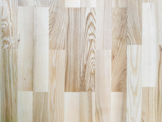 Wooden background made of natural wood planks parquet with pattern of lines and knot for wallpaper in beige color used in carpentry and flooring
