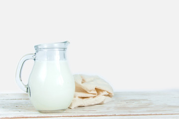 Kefir in a jug on a white background. The concept of diet and healthy eating. Fermented dairy products.