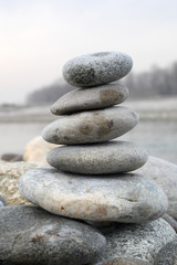 Fototapeta na wymiar zen stone concept: piled stone on a river side with copy space for your text