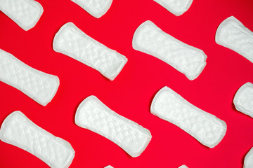 top view clean sanitary pads pattern  on a vibrant  red background